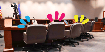 Chairs are pictured at a rounded table
